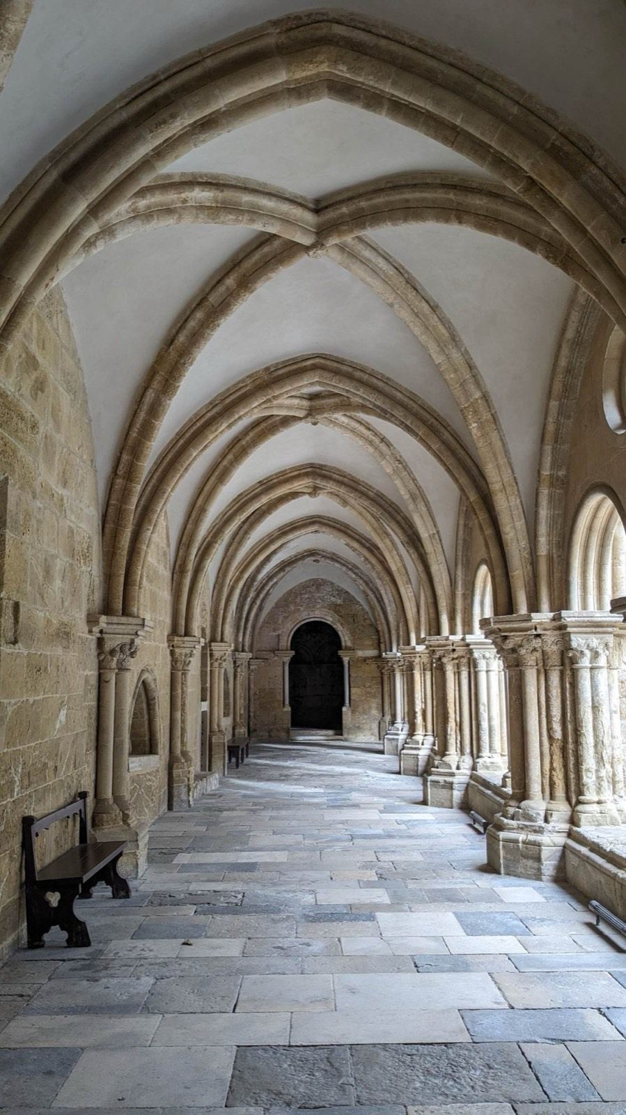 Vaulted stone cloister corridor in Coimbra