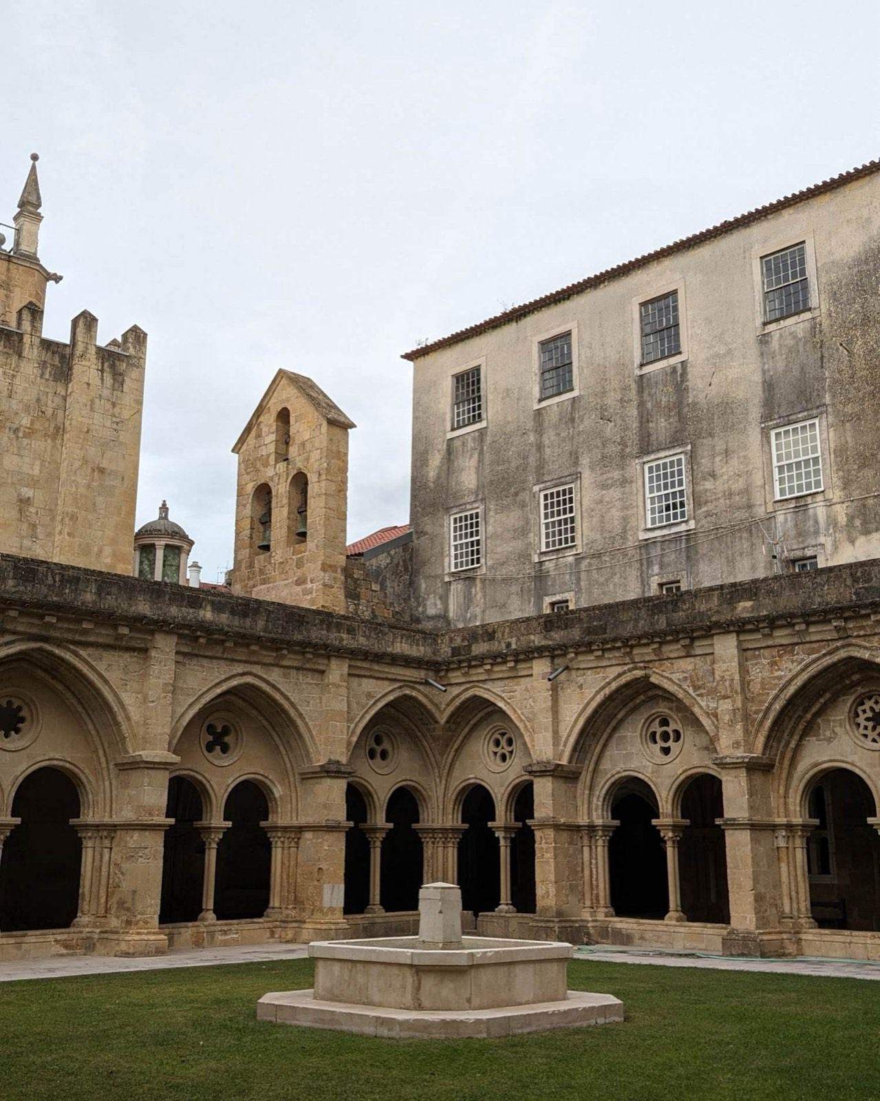 Cloister and courtyard of an old stone building in Coimbra
